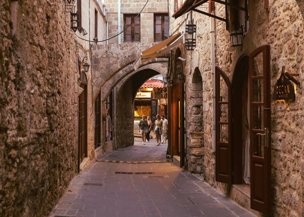 Rhodes Things To Do_a-narrow-alley-way-with-people-walking-down-it