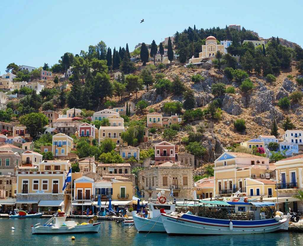 Symi Island the perfect place to relax_blue-and-white-boat-on-body-of-water-near near-green-trees-during-daytime